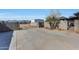 Long gated driveway leading to a large metal building and barn at 7528 N 185Th Ave, Waddell, AZ 85355