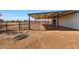 Covered stalls and fenced area adjacent to a metal stable at 7528 N 185Th Ave, Waddell, AZ 85355