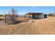 Exterior view of a metal horse stable with a covered area at 7528 N 185Th Ave, Waddell, AZ 85355