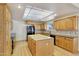 Modern kitchen with light wood cabinets, large island, and tile flooring at 7528 N 185Th Ave, Waddell, AZ 85355