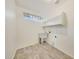 Laundry room with tile flooring, utility sink, and shelving at 7528 N 185Th Ave, Waddell, AZ 85355