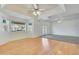 Bright living room with hardwood floors, ceiling fan, and views of the backyard at 7528 N 185Th Ave, Waddell, AZ 85355