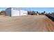 Large metal building with double garage doors at 7528 N 185Th Ave, Waddell, AZ 85355