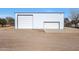 Large metal building with double garage doors at 7528 N 185Th Ave, Waddell, AZ 85355