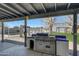 Built-in stainless steel grill under covered patio at 7528 N 185Th Ave, Waddell, AZ 85355