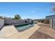 Relaxing rectangular pool with a slide, surrounded by a brick patio at 7528 N 185Th Ave, Waddell, AZ 85355