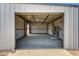 Spacious interior of a metal storage building with open garage door at 7528 N 185Th Ave, Waddell, AZ 85355