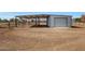 Metal storage shed with roll-up door, providing extra storage space at 7528 N 185Th Ave, Waddell, AZ 85355