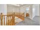 Upstairs hall with wood railings and carpet flooring at 7528 N 185Th Ave, Waddell, AZ 85355