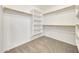 Large walk-in closet with shelving and hanging rods at 7528 N 185Th Ave, Waddell, AZ 85355