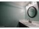 Small bathroom with updated vanity and oval mirror at 8225 N Central Ave # 46, Phoenix, AZ 85020