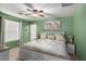 Light and airy bedroom with a light wood bed frame and green walls at 875 S Brewer Dr, Gilbert, AZ 85296