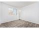 Spacious bedroom featuring wood-look floors and a window with blinds at 910 W Prior Ave, Coolidge, AZ 85128