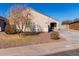 Front yard view of a house with mature trees and gravel at 910 W Prior Ave, Coolidge, AZ 85128