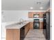 Modern kitchen with oak cabinets and black appliances at 910 W Prior Ave, Coolidge, AZ 85128