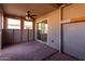 Covered patio with ceiling fan and sliding glass door at 910 W Prior Ave, Coolidge, AZ 85128