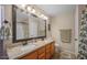 Double sink bathroom with granite countertop and large mirror at 9176 N 82Nd Ln, Peoria, AZ 85345