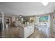 Open concept kitchen with island, dining area, and views into the living room at 9176 N 82Nd Ln, Peoria, AZ 85345