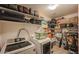 Well-organized laundry room with washer, dryer, and ample storage shelving at 9176 N 82Nd Ln, Peoria, AZ 85345