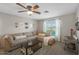 Living room featuring a sectional sofa, coffee table, and ceiling fan at 9176 N 82Nd Ln, Peoria, AZ 85345