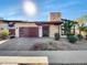 Modern home with brown garage door and stone accents at 925 E Piedmont Rd, Phoenix, AZ 85042