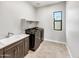 Laundry room with washer, dryer, and built in cabinets at 925 E Piedmont Rd, Phoenix, AZ 85042