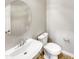 Small powder room with white vanity and round mirror at 925 E Piedmont Rd, Phoenix, AZ 85042