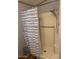 Small bathroom with shower/tub combo and striped shower curtain at 9302 E Broadway Rd # 103, Mesa, AZ 85208