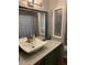 Bathroom features a sink, large mirror, and shower at 9302 E Broadway Rd # 103, Mesa, AZ 85208