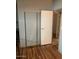 Spare bedroom with sliding closet doors and wood-look flooring at 9302 E Broadway Rd # 103, Mesa, AZ 85208