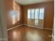 Well-lit bedroom with hardwood floors and plantation shutters at 945 N Pasadena St # 113, Mesa, AZ 85201