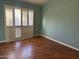 Bedroom with hardwood floors and plantation shutters at 945 N Pasadena St # 113, Mesa, AZ 85201