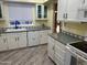 Efficient kitchen with white cabinets and modern appliances at 945 N Pasadena St # 113, Mesa, AZ 85201