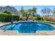 Inviting kidney-shaped pool with a spacious patio and mountain views at 1431 E Dry Creek Rd, Phoenix, AZ 85048