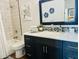 Modern bathroom with dark vanity, tile shower, and bathtub at 17234 N 28Th St, Phoenix, AZ 85032