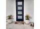 Modern front door entrance with navy blue door and welcome mat at 17234 N 28Th St, Phoenix, AZ 85032