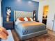 Main bedroom with tufted headboard and orange accents at 17234 N 28Th St, Phoenix, AZ 85032