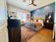 Main bedroom with tufted headboard and wood floors at 17234 N 28Th St, Phoenix, AZ 85032