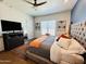 Main bedroom with tufted headboard and ceiling fan at 17234 N 28Th St, Phoenix, AZ 85032