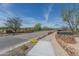 Landscaped community road with stone and iron accents at 18231 E Coronado Cave Ct, Rio Verde, AZ 85263