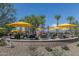 Relaxing pool area with fire pit and yellow umbrellas at 18231 E Coronado Cave Ct, Rio Verde, AZ 85263