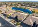 Aerial view of house and community, showcasing a lake and golf course at 20621 N Canyon Whisper Dr, Surprise, AZ 85387