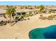 Backyard oasis with lake view and desert landscaping at 20621 N Canyon Whisper Dr, Surprise, AZ 85387