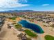 Community overview showing homes, golf course, and lake views at 20621 N Canyon Whisper Dr, Surprise, AZ 85387