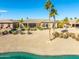 Stunning backyard view of house, landscaping and water feature at 20621 N Canyon Whisper Dr, Surprise, AZ 85387