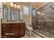 Bathroom with a walk-in shower and wood vanity at 20621 N Canyon Whisper Dr, Surprise, AZ 85387