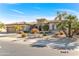 Exterior of house, three-car garage, and lush landscaping at 20621 N Canyon Whisper Dr, Surprise, AZ 85387