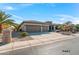 House exterior featuring a three-car garage and landscaped yard at 20621 N Canyon Whisper Dr, Surprise, AZ 85387