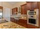 Kitchen boasts granite countertops and double ovens at 20621 N Canyon Whisper Dr, Surprise, AZ 85387