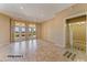Spacious living room with tile floors and backyard access at 20621 N Canyon Whisper Dr, Surprise, AZ 85387